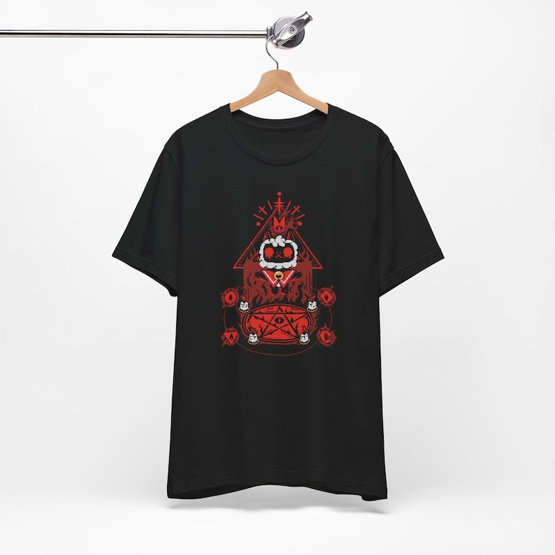 May include: Black t-shirt with a red graphic of a cartoon character wearing a crown and a pentagram. The character is surrounded by a red pentagram and red eyes.