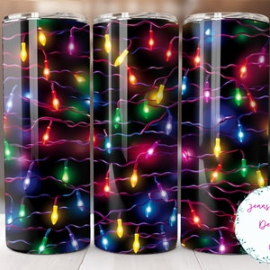 May include: Three stainless steel tumblers with a black background and a pattern of colorful Christmas lights. The tumblers are all the same size and shape.