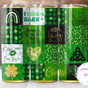 May include: Three green and gold tumbler cups with a patchwork design featuring shamrocks, rainbows, hearts, and the text "Kiss me I'm Irish", "I'm Irish", "Happy St. Patrick's Day", "Lucky", "Cheers", and a Celtic knot.