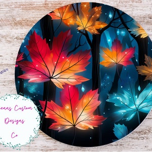 May include: A round, dark blue background with a pattern of glowing red, orange, and blue maple leaves. The leaves are illuminated with small white lights.