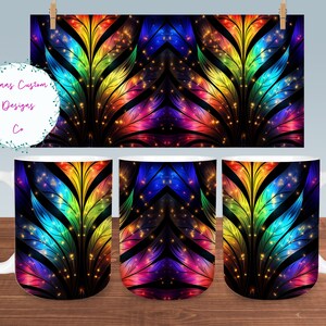 May include: A set of three white ceramic mugs with a colorful abstract design featuring rainbow colors and sparkling lights. The design is a symmetrical pattern of feathers with a black background.