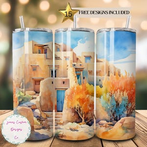 May include: A watercolor painting of a Southwestern adobe building with a blue door. The building is surrounded by desert plants and rocks. The painting is on a stainless steel tumbler.