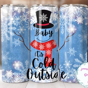 May include: A white tumbler with a blue background and a snowman design. The snowman is wearing a black top hat, a red scarf, and has the text "Baby it's Cold Outside" on it.
