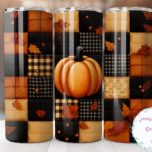 May include: A fall-themed tumbler with a patchwork design featuring a pumpkin, leaves, and plaid patterns in shades of brown, black, and cream.