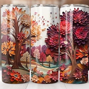 May include: Three stainless steel tumblers with a colorful paper art design of trees and flowers in shades of orange, red, purple, and brown. The tumblers are perfect for holding hot or cold beverages.