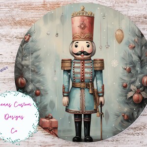 May include: A blue and red Christmas nutcracker figurine stands in front of a blue and green Christmas tree with red and gold ornaments. The nutcracker is holding a stick in its right hand. The background is a light blue with snowflakes.
