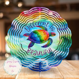 May include: A colorful metal wind spinner with a rainbow sea turtle and the words "Different is Beautiful".
