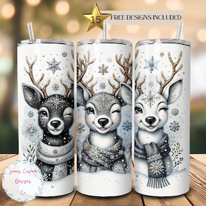 May include: Three stainless steel tumblers with a white background and a design of three cartoon reindeer wearing scarves and snowflakes. The text "FREE DESIGNS INCLUDED" is at the top of the image.