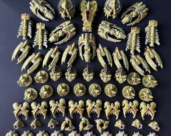 May include: A collection of 30 miniature plastic figures, painted in a beige and white color scheme, with red accents. The figures are arranged in rows and columns on a black surface. The figures are detailed and intricate, with sharp edges and points.