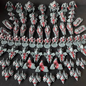 May include: A selection of grey and red miniature figurines, including robots, shields, and spacecraft. The figurines are arranged in rows and columns, showcasing a variety of designs and sizes. The red accents provide contrast against the grey bodies, creating a futuristic aesthetic.