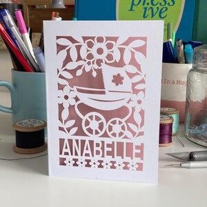A personalised Cricut template for a new baby card SVG with a vintage pram and a name