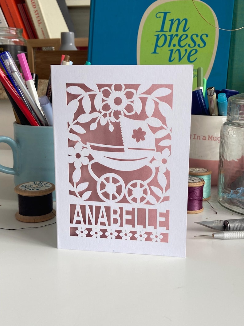 A personalised Cricut template for a new baby card SVG with a vintage pram and a name