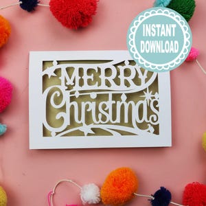 May include: A white Christmas card with the words "MERRY Christmas" cut out, revealing a gold background. The card is decorated with colourful pom-poms. A circular badge with "INSTANT DOWNLOAD" is in the upper right corner.