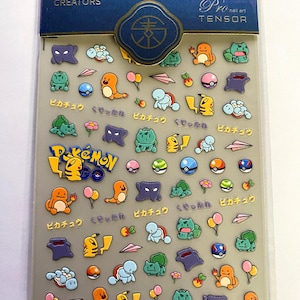 May include: Clear sheet of nail art stickers featuring colorful cartoon characters, including Pikachu and other Pokemon. The sheet includes the text "DANCE WITH CREATORS" and "Pro nail art TENSOR".