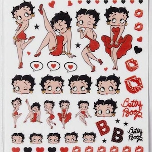 May include: Sheet of Betty Boop stickers. The stickers feature the cartoon character in various poses, wearing a red dress, alongside hearts, lips, and the text "Betty Boop". The background is white.