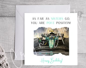 May include: A birthday card with a green and black race car on a white background. The card reads "As far as sisters go, you are pole position!" and "Happy Birthday!"