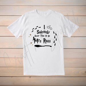 May include: White t-shirt with a black graphic design that says "I Solemnly Swear That I'll Be Mrs. Ross". The graphic also includes a broom, a witch's hat, and footprints.