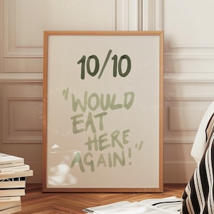 Peut inclure: Une impression encadrée avec un fond blanc et du texte vert qui dit "10/10 "J'aimerais manger ici à nouveau !"