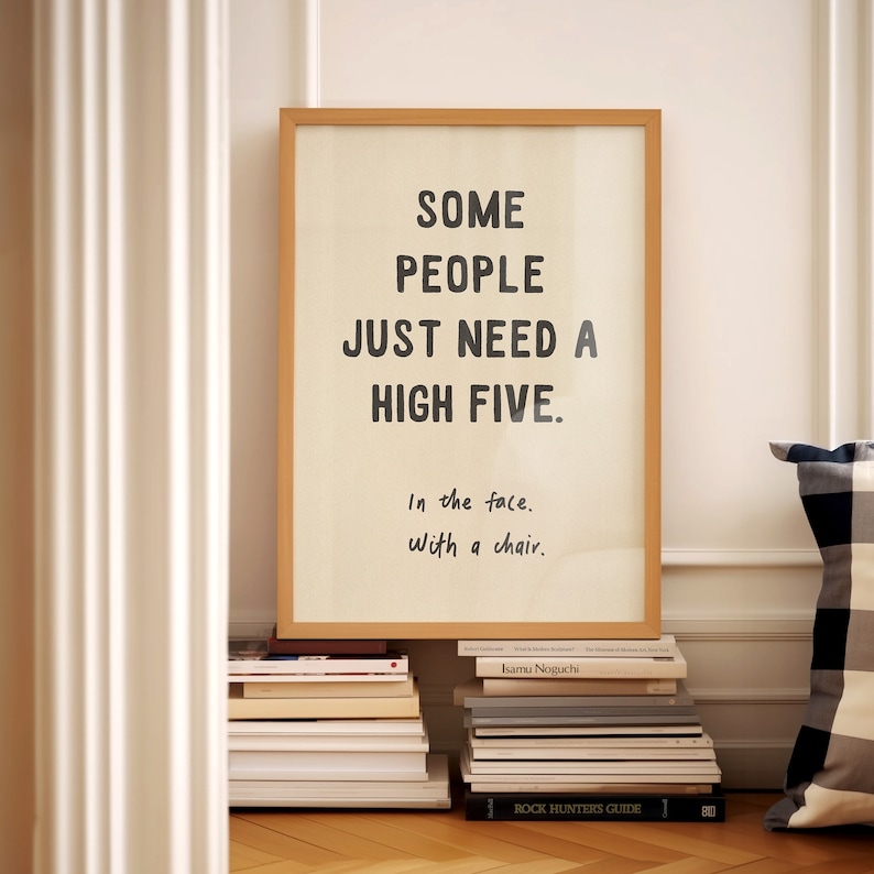 May include: A framed print with a white background and black text that reads "SOME PEOPLE JUST NEED A HIGH FIVE. In the face. With a chair."