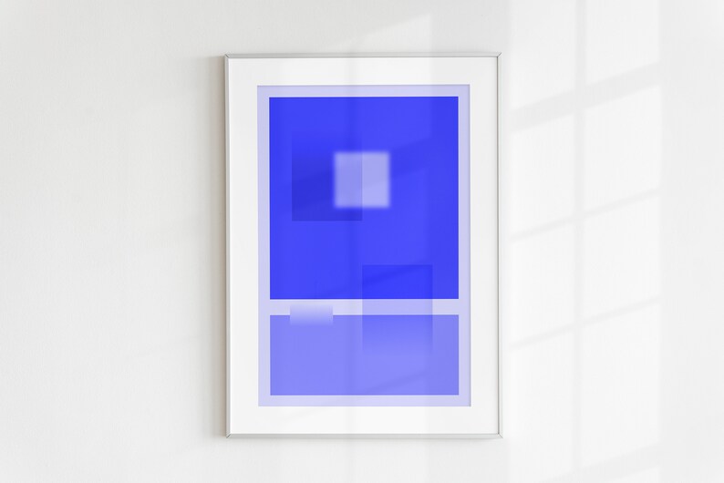 May include: A framed abstract art print with a blue background and white geometric shapes. The print is in a silver frame.