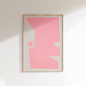 May include: A framed abstract art print featuring a pink geometric shape against a light grey background.