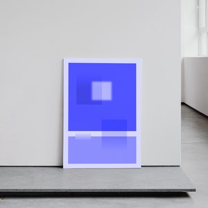 May include: A framed abstract art print with a blue and white geometric design. The print is hanging on a white wall.