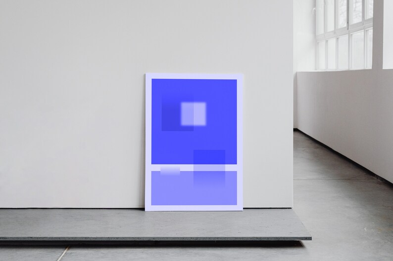 May include: A framed abstract art print with a blue and white geometric design. The print is hanging on a white wall.