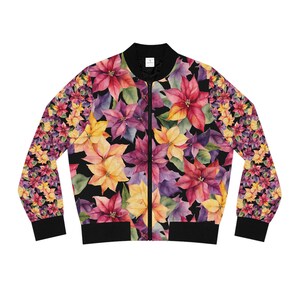 May include: A black bomber jacket with a floral print featuring poinsettia flowers in shades of red, yellow, pink, and purple. The jacket has a zipper closure and ribbed cuffs and hem.