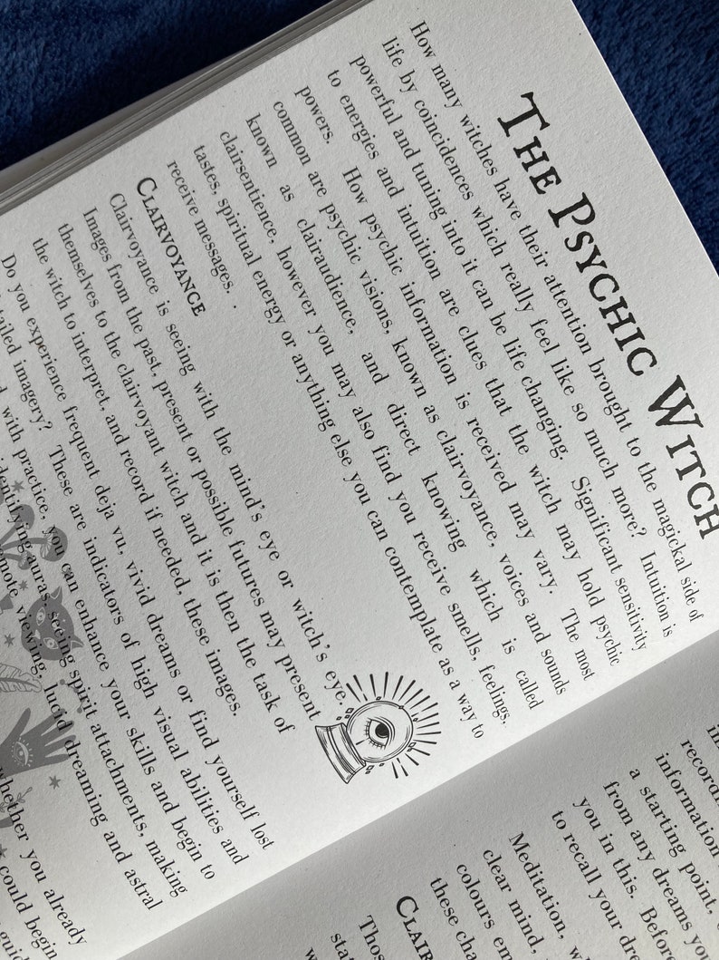 May include: A book cover with the title "The Psychic Witch" in black text. The cover features a black and white illustration of a crystal ball with an eye inside. The text below the title reads "How many witches have their attention brought to the magickal side of life by coincidences which really feel like so much more?"