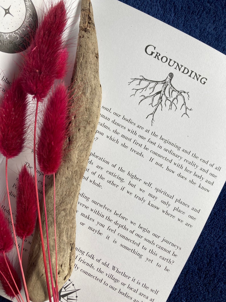 May include: A book with the word "Grounding" printed on the cover. The book is open to a page with a black and white illustration of a tree with roots. The text on the page discusses the concept of grounding and how it relates to the higher self.