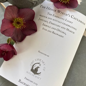 May include: A white booklet titled "The Hedge Witch's Cauldron: The Emerging Light" with the text "Magick and Rituals Celebrating January, February and March, Imbolc and Ostara, Stir and Reawaken." The booklet is produced by "The Library of Witchcraft" and is dated February 2023.