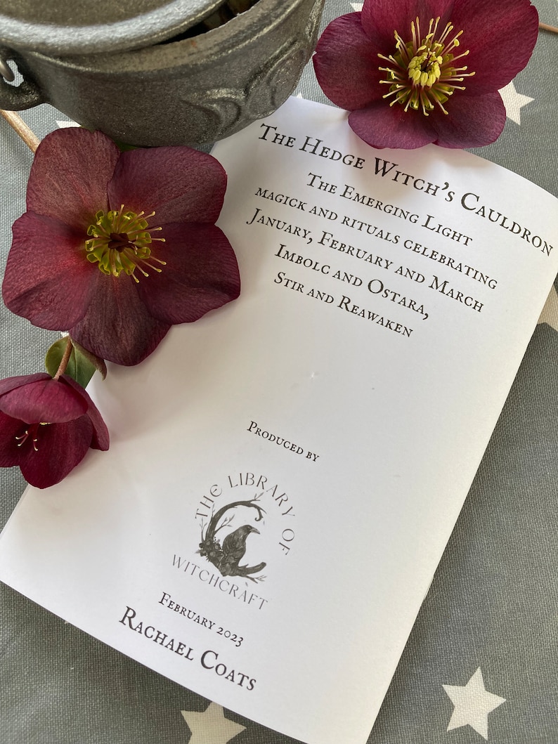 May include: A white booklet titled "The Hedge Witch's Cauldron: The Emerging Light" with the text "Magick and Rituals Celebrating January, February and March, Imbolc and Ostara, Stir and Reawaken." The booklet is produced by "The Library of Witchcraft" and is dated February 2023.