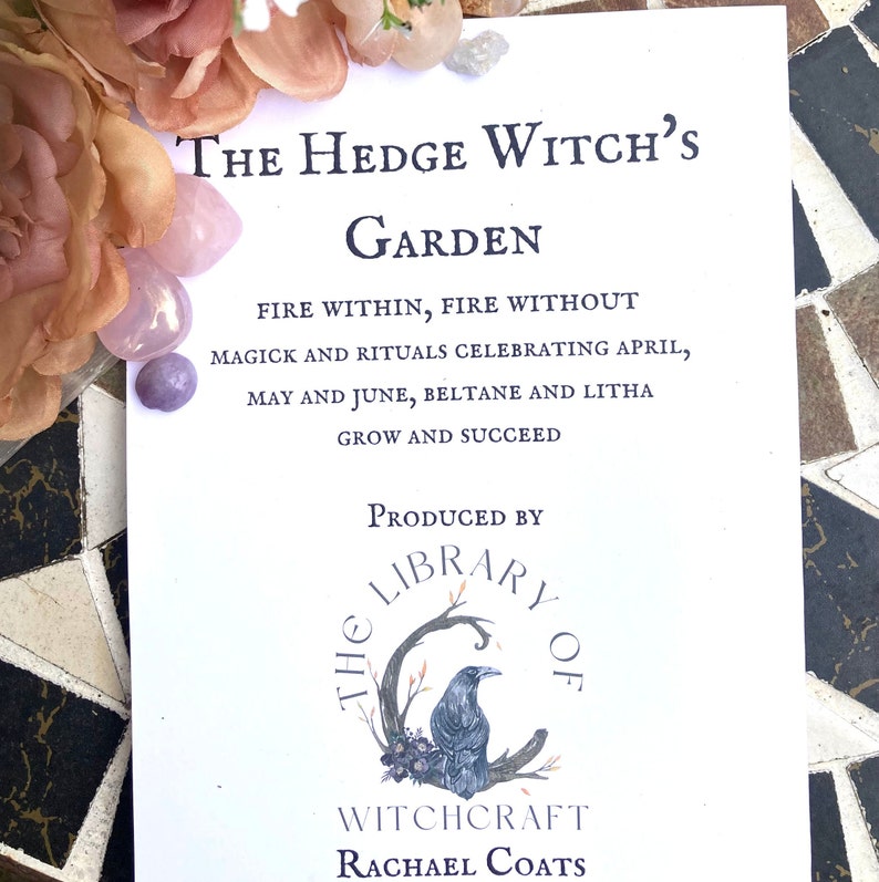 May include: A white card with black text that reads "The Hedge Witch's Garden Fire Within, Fire Without Magick and Rituals Celebrating April, May and June, Beltane and Litha Grow and Succeed" and a black and white illustration of a raven on a branch with the text "The Library of Witchcraft Rachael Coats" below.