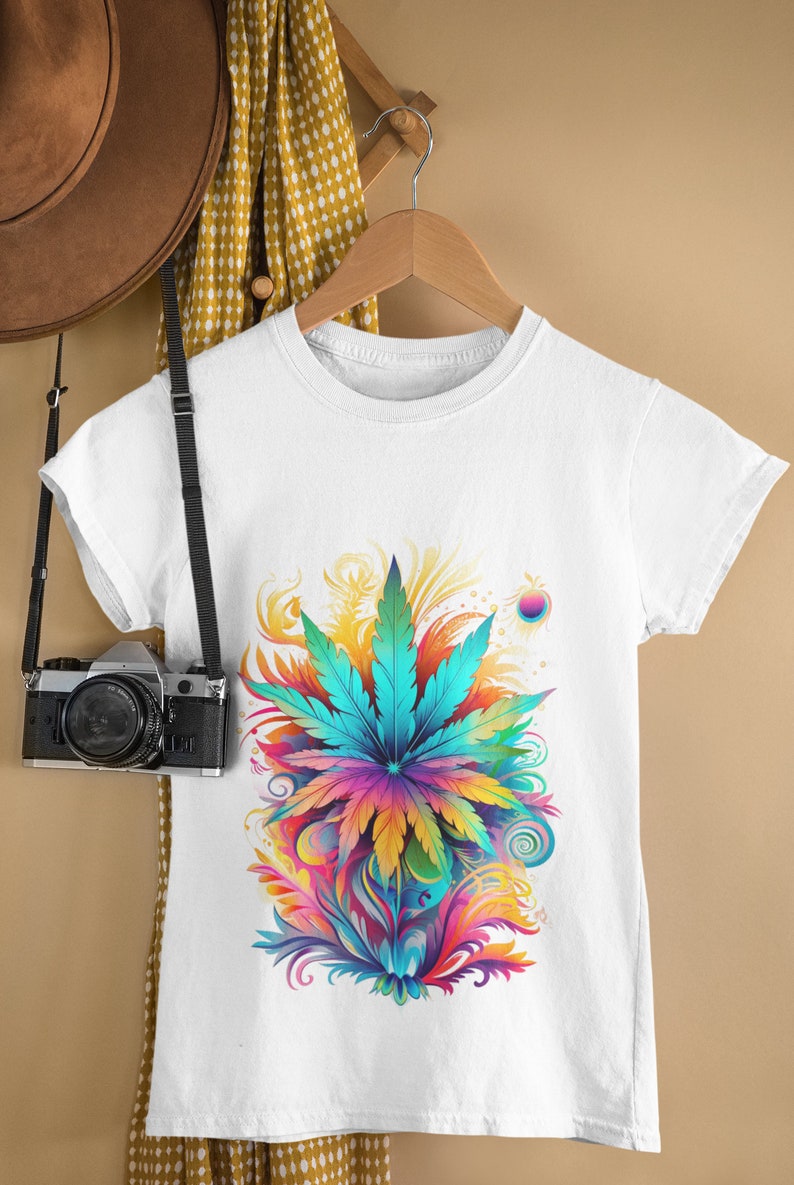 May include: White t-shirt with a colorful graphic of a marijuana leaf surrounded by swirls and abstract shapes.