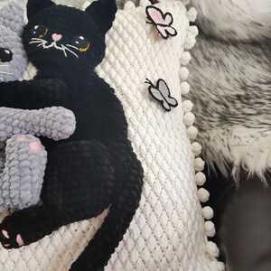 This handmade white knitted pillowcase features a unique and charming design, showcasing crocheted with 3D black and grey soft kitties and butterflies