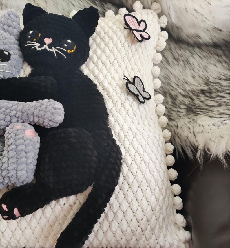 This handmade white knitted pillowcase features a unique and charming design, showcasing crocheted with 3D black and grey soft kitties and butterflies