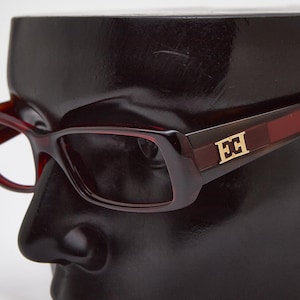 2000s vintage ESCADA red and brown slim rectangular shades,narrow futuristic frames,Y2K eyeglasses,fancy shadow,urban fashionistas Y2K