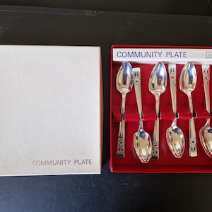 May include: A set of six silver Community Plate teaspoons in a red box with a white label that reads "Community Plate".