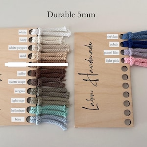 May include: Two wooden display boards labeled Labini Handmade featuring 5mm cord samples in various colors. The left board displays white, ivory, white pepper, sand, coffee, warm taupe, seegras, light sage, hellminze, and blau. The right board shows seeblau, cobalt, pastel lilac, and light pink.