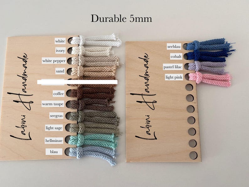 May include: Two wooden display boards labeled Labini Handmade featuring 5mm cord samples in various colors. The left board displays white, ivory, white pepper, sand, coffee, warm taupe, seegras, light sage, hellminze, and blau. The right board shows seeblau, cobalt, pastel lilac, and light pink.