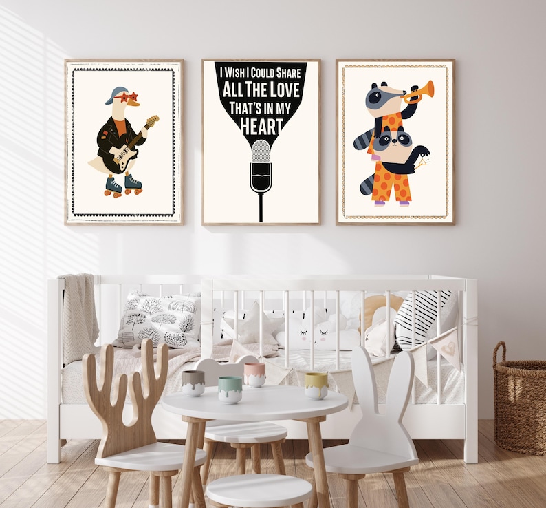 May include: Three framed art prints with a whimsical theme. One features a goose playing a guitar and wearing roller skates. Another displays the text "I wish I could share all the love that's in my heart." The third shows raccoons playing a trumpet.
