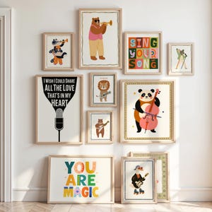 May include: A collection of framed art prints featuring whimsical animal illustrations. The prints include a bear playing a trumpet, a panda with a cello, and a lion with a guitar. Some prints have text that reads "Sing Your Song" and "You Are Magic."