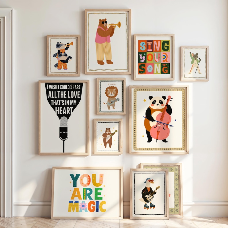 May include: A collection of framed art prints featuring whimsical animal illustrations. The prints include a bear playing a trumpet, a panda with a cello, and a lion with a guitar. Some prints have text that reads "Sing Your Song" and "You Are Magic."