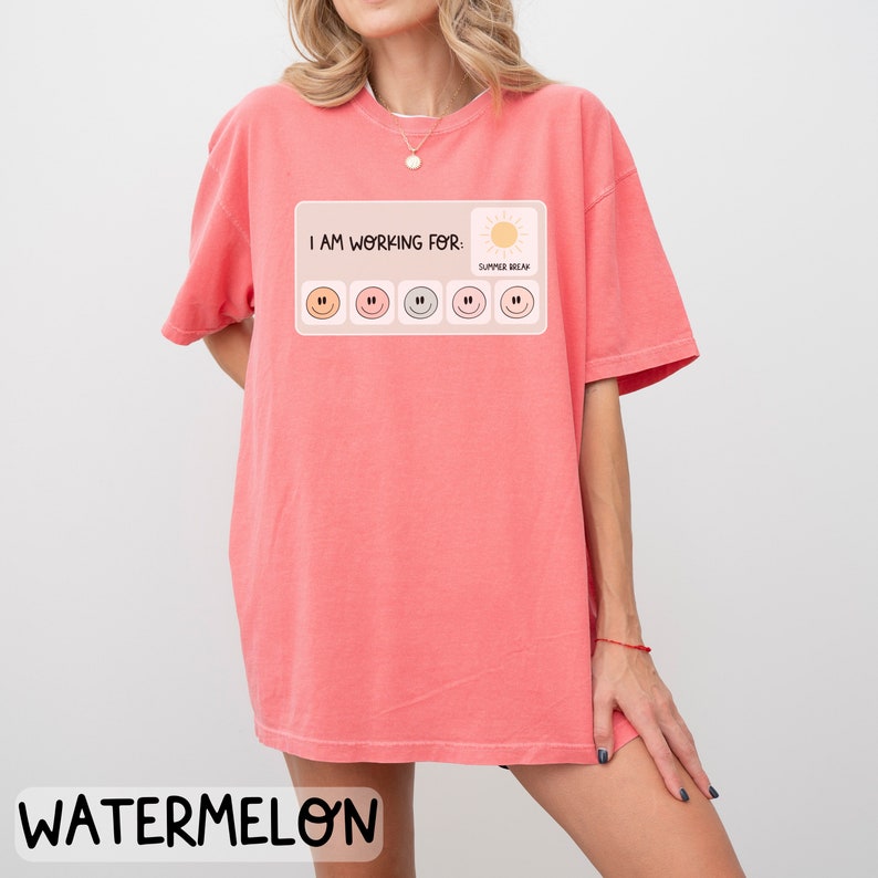 May include: A pink t-shirt with the text "I am working for: Summer Break" and a progress bar with smiley faces. The progress bar is filled with five smiley faces.