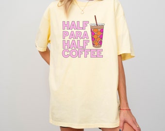 May include: A yellow t-shirt with the text "HALF PARA HALF COFFEE" in pink letters and a cartoon image of a coffee cup with a straw.