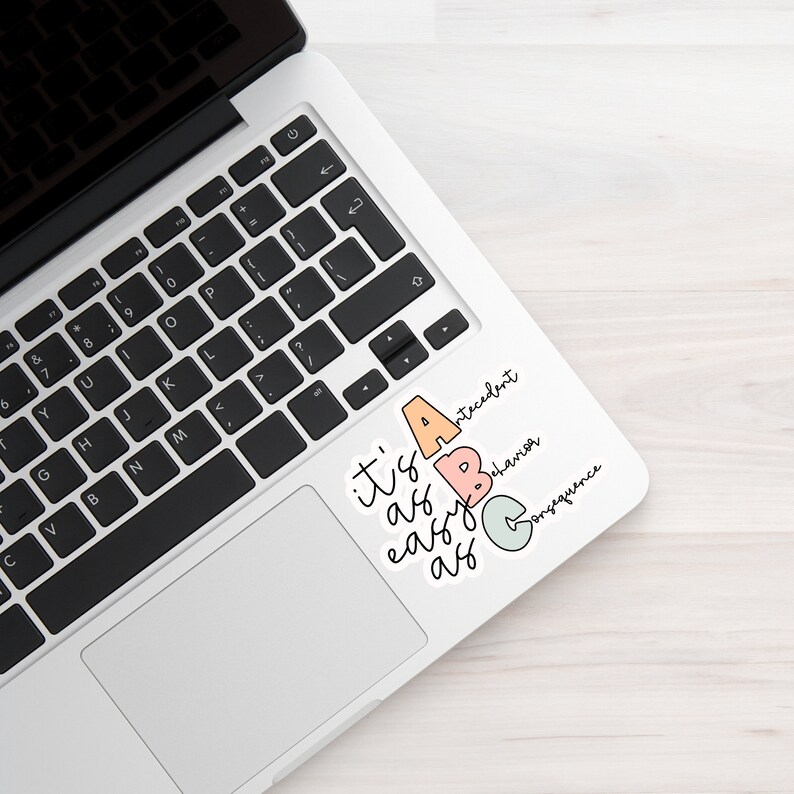 May include: A sticker on a laptop that says "it's as easy as ABC" with the letters A, B, and C in different colors and the words "antecedent", "behavior", and "consequence" written next to each letter.