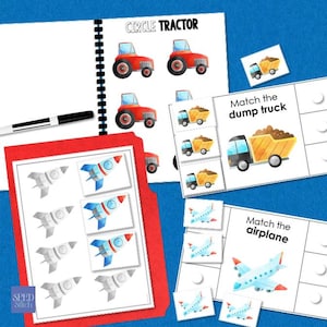 May include: A collection of educational matching games for children. The image shows a spiral-bound notebook with red tractors and the text "CIRCLE TRACTOR". There are also cards with dump trucks, airplanes, and rockets. A black marker and a red folder are also visible.
