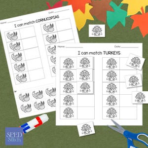 May include: Two worksheets with the text "I can match CORNUCOPIAS" and "I can match TURKEYS" with matching activities. The worksheets are on a green surface with fall-themed cutouts, a glue stick, and scissors.