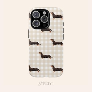 May include: A phone case with a repeating pattern of dachshund dogs on a beige and white gingham background. The case has a black border and a camera cutout. The word "NINETY4" is at the bottom.