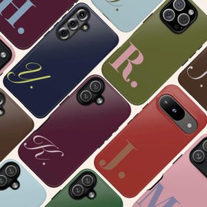 May include: A collection of colorful phone cases, each featuring a different initial in a stylish font. The cases are in various shades, including blue, green, red, and pink. The image showcases a variety of phone models.